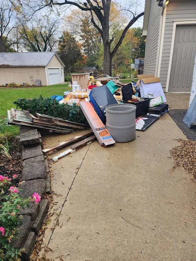 Dumpster being loaded with debris for Roofing Dumpster Rental in Brownsville